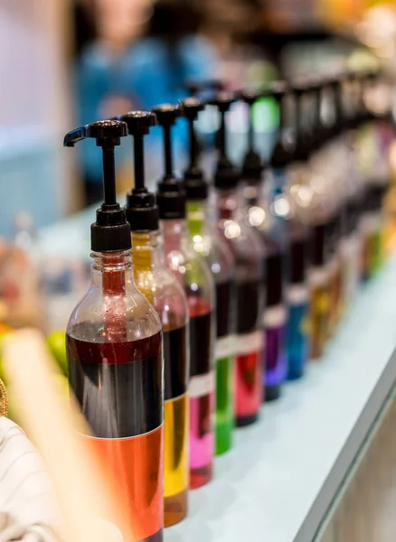 Row of pump head bottle of beverage in the cafe. — Stock Photo, Image