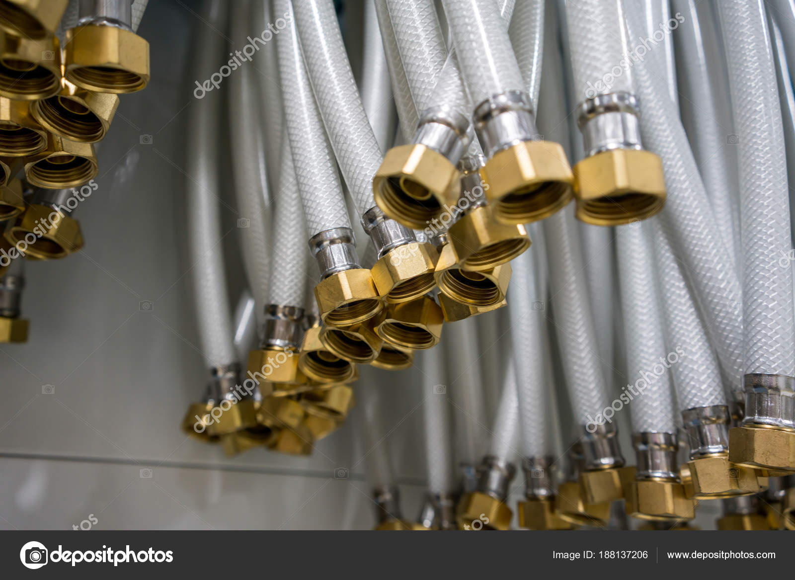 Group of white flexible rubber hose with brass nut connector — Stock