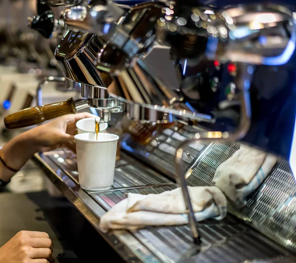 Barista hand setting up the coffee machine in vintage design