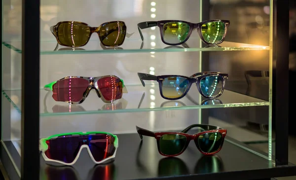 Various of sun glasses in the shop display shelves.