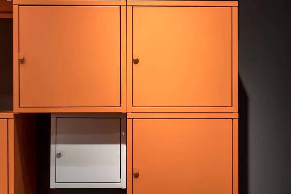 Colorful metal cabinets hanging on black wall