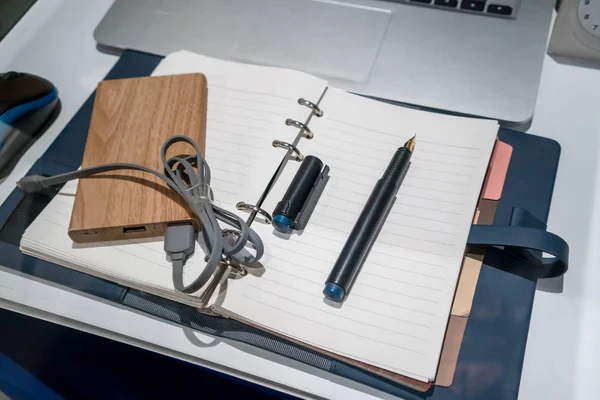 Pocket battery charger and fountain pen on blue leather organize — Stock Photo, Image