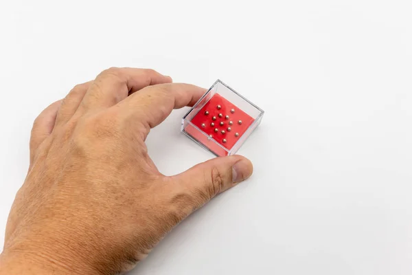 Mini juego de pelota en caja de plástico cuadrado claro aislado en blanco — Foto de Stock