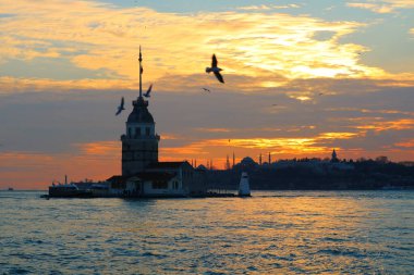 Kızların Kulesi, namı diğer Kiz Kulesi, gün batımında. Arka planda İstanbul şehri manzarası var. İstanbul arka plan fotoğrafı. İstanbul 'a seyahat. 