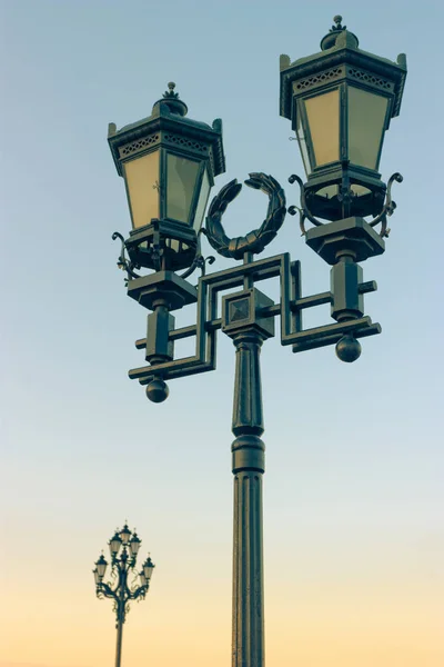 The old retro lamp post and the beautiful blue sky