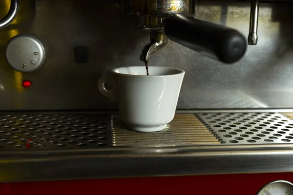 Close-up of coffee machine. Coffee machine preparing fresh coffee and pouring into cups at restaurant.