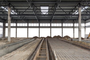 İnşaat alanı. Metal çerçeveli alüminyum çatı. Yapıyı iki güçlendirilmiş beton kiriş tutuyor. Hangarın inşaatı. Arkaplan izole edildi.