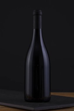 Bir siyah, ahşap arka plan ve Black Label izole kırmızı şarap şişe