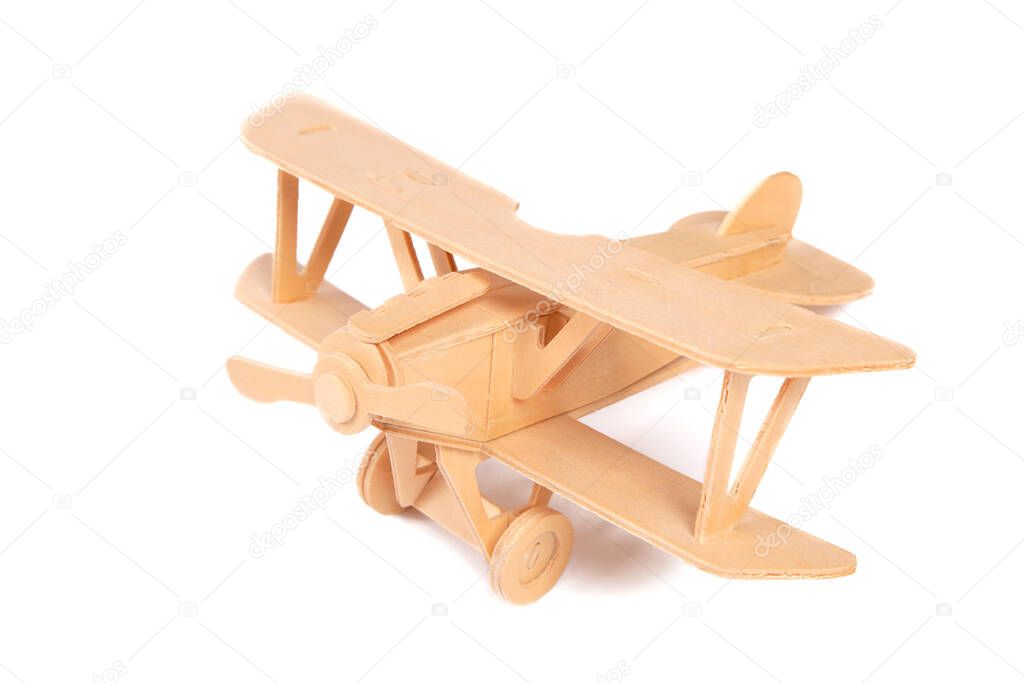 wooden biplane plane on a white background. Games for boys, children's creativity, handmade. Educational classes with children. Military holidays-Victory Day, February 23. To avoid war.