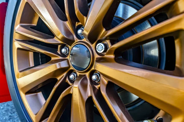 Close up of a car's orange rim, wheel with no emblem — Stock Photo, Image