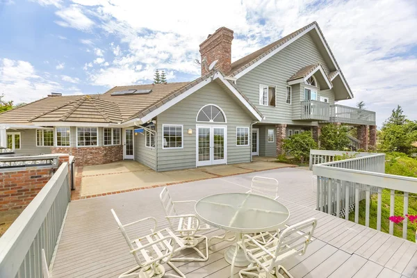 Day shot of a wonder California home with a large deck and seati