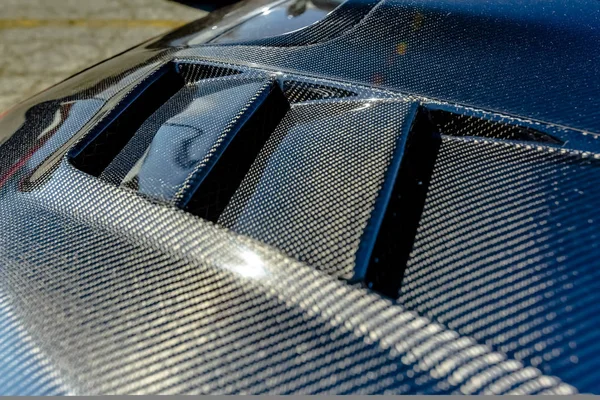 Kevlar carbon fiber texture on a car hood — Stock Photo, Image