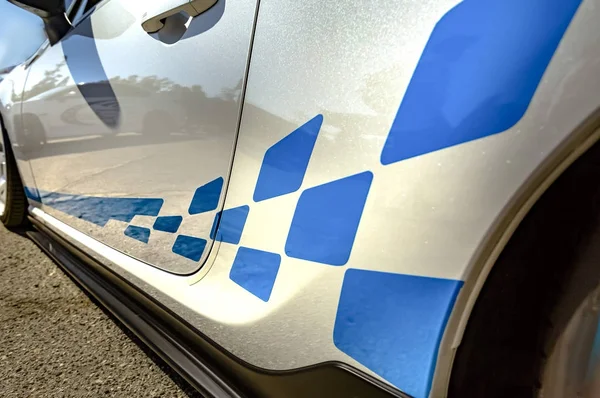 White car with blue strips and pattern closeup shot from the sid — Stock Photo, Image