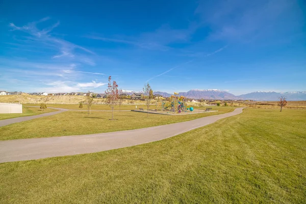 Long empty pedestrian walkway in an urban park