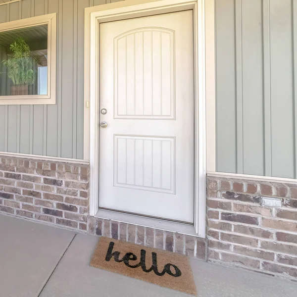 Square frame Front door and veranda of home with welcome mat