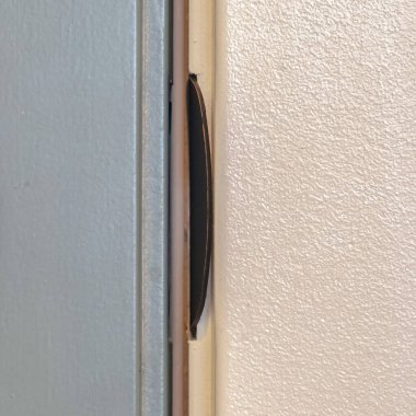 Square Close up of unlocked deadbolt latch on home door