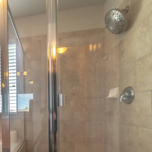 Square frame Glass walled shower stall and circular bathtub inside modern bathroom of home