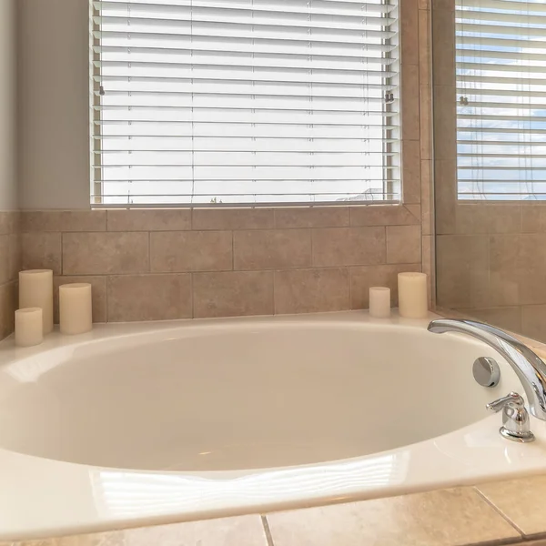 Square frame Close up of circular built in bathtub in front of window inside a home bathroom — Stock Photo, Image