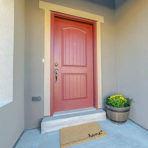 Square frame Red wooden front door at the entrance of a home with concrete exterior wall — ストック写真