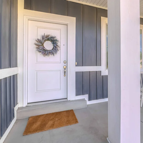 Square Front door and porch area of modern suburban home