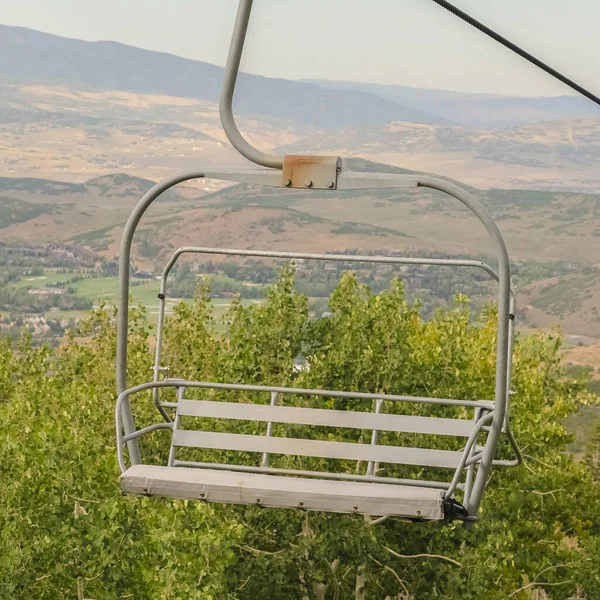 Vierkante frame Close-up van stoeltjeslift met uitzicht op Park City skigebied tijdens het laagseizoen — Stockfoto