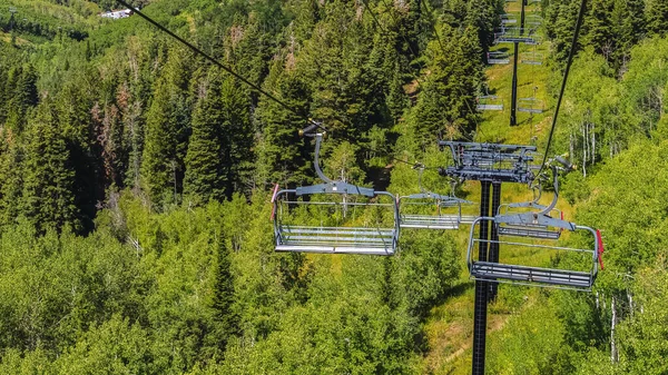 Panorama stoeltjesliften over wandelpaden en bomen op de berg met gebouwen in Park City — Stockfoto