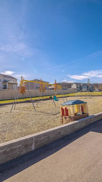 Vertical Empty pedestrian walkway passing a kids playground