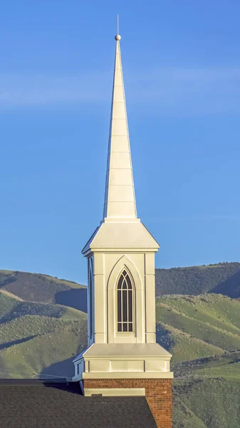 Vertical frame Focus on the roof and steeple of a church with classic red brick exterior wall — Stock Photo, Image