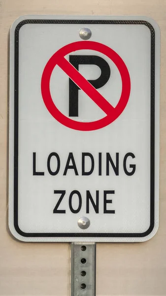 Vertical frame No Parking sign for vehicles for a Loading Zone