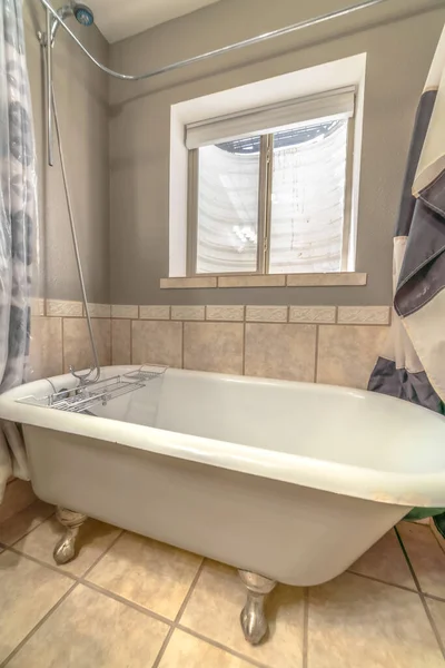 Close up of bathtub and shower inside a bathroom with tiles on wall and floor — Stock Photo, Image