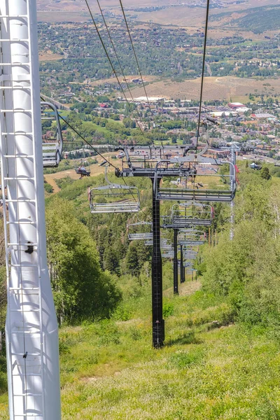 Chairlifts overlooking hiking trails and building on a summer day in Park City