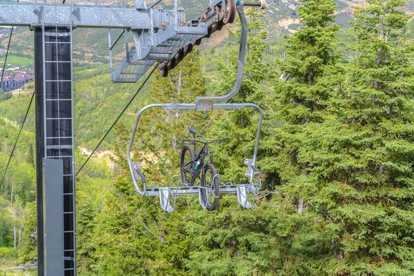 Горный велосипед на лифте против деревьев в горнолыжном курорте Парк-Сити в межсезонье — стоковое фото
