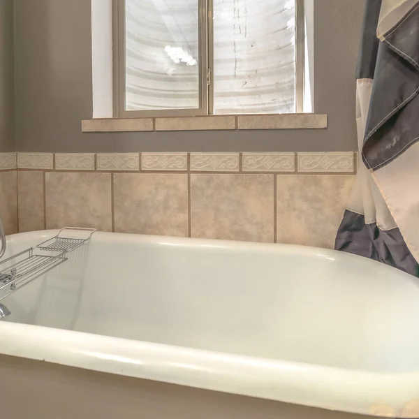 Square Close up of a bathtub in side a bathroom with shower curtains and window — Stock Photo, Image