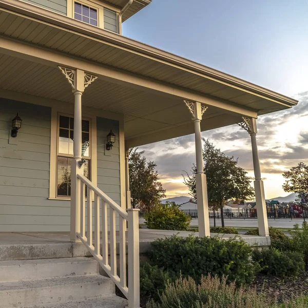 Square Steps and covered porch on a timber clad house