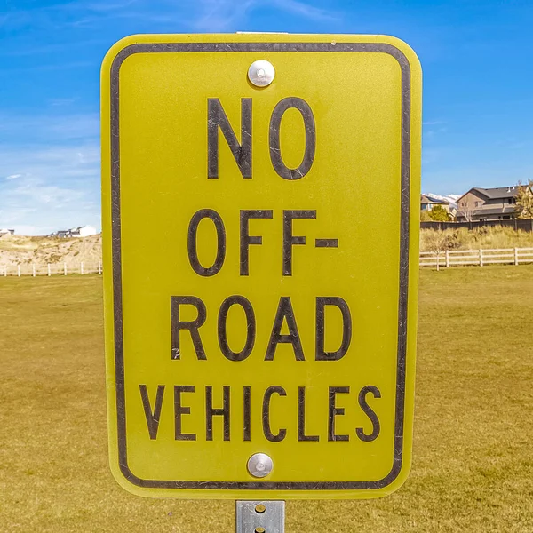 Square frame Road sign on a grassy field - No Off-road vehicles