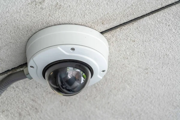 Close up of a cctv dome video security camera installed outside a building — Stock Photo, Image