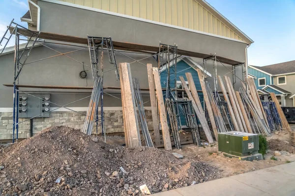 Residential construction with scaffolding and wooden beams against wall of home — 스톡 사진