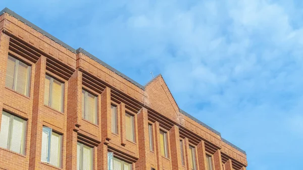 Pano Exterior of a multi storey building with red brick walls and tall glass windows — 스톡 사진