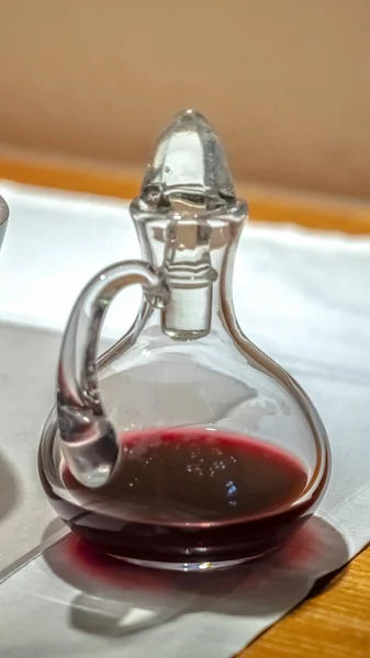 Vertical frame Glass carafe with red communion wine indoor — 스톡 사진