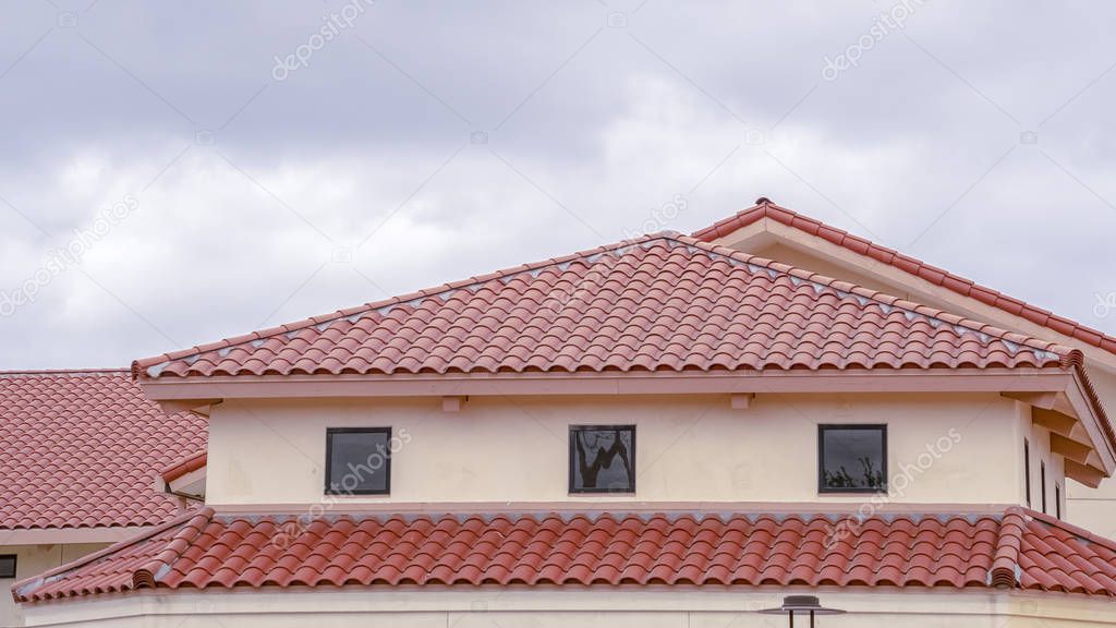 Panorama Tiled roof on a building with ventilation windows