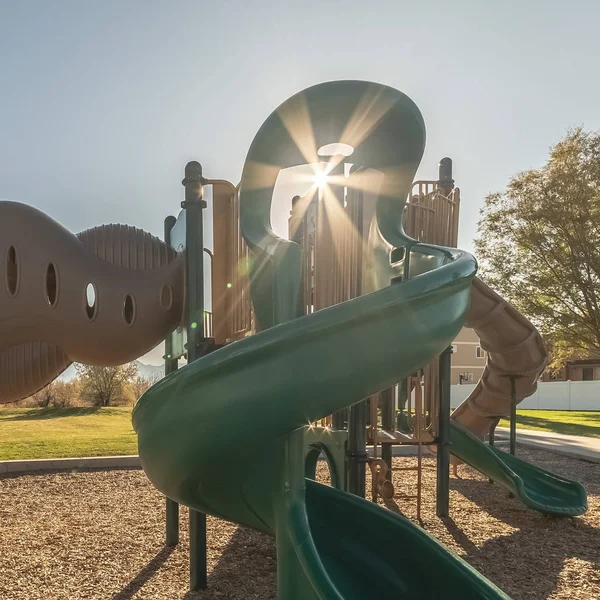 Square Sunburst through equipment on a kids playground — ストック写真