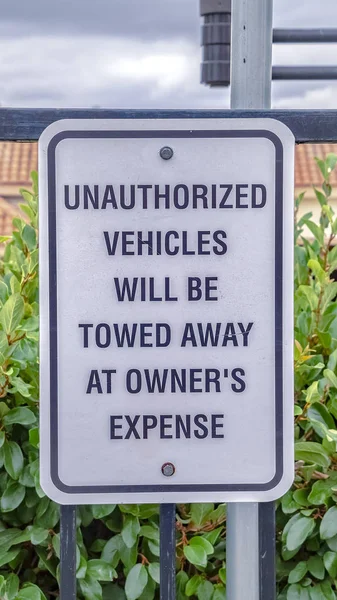 Vertical frame No parking for unauthorized vehicles warning sign