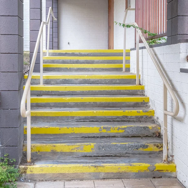 Escaleras exteriores cuadradas con pisadas amarillas de advertencia en un día soleado —  Fotos de Stock