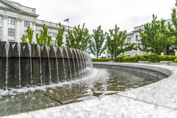 Circular water fountain with Utah State Capital Building in Salt Lake City