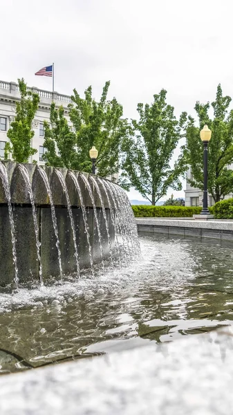 Vertical Circular water fountain with Utah State Capital Building in Salt Lake City