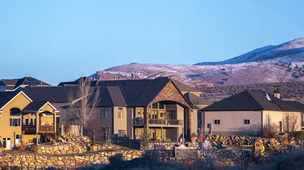 Panorama frame Distant houses against snow covered hills day light — 스톡 사진