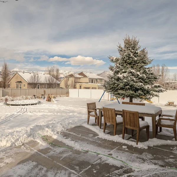 Square frame Swept exterior patio with garden in winter snow