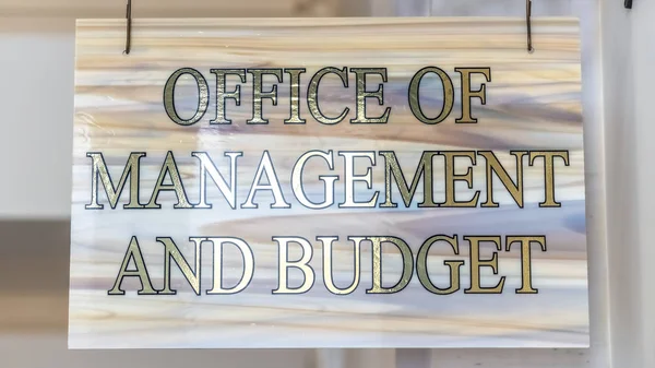 Panorama frame Office Of Management And Budget sign hanging on decrative wrought iron hanger