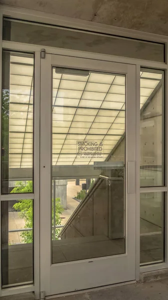 Vertical Glass door and wall at the balcony of building with stairs on the other side