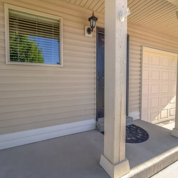 Square Home with small concrete porch in front of brown wooden door and shiny window — Stock Photo, Image